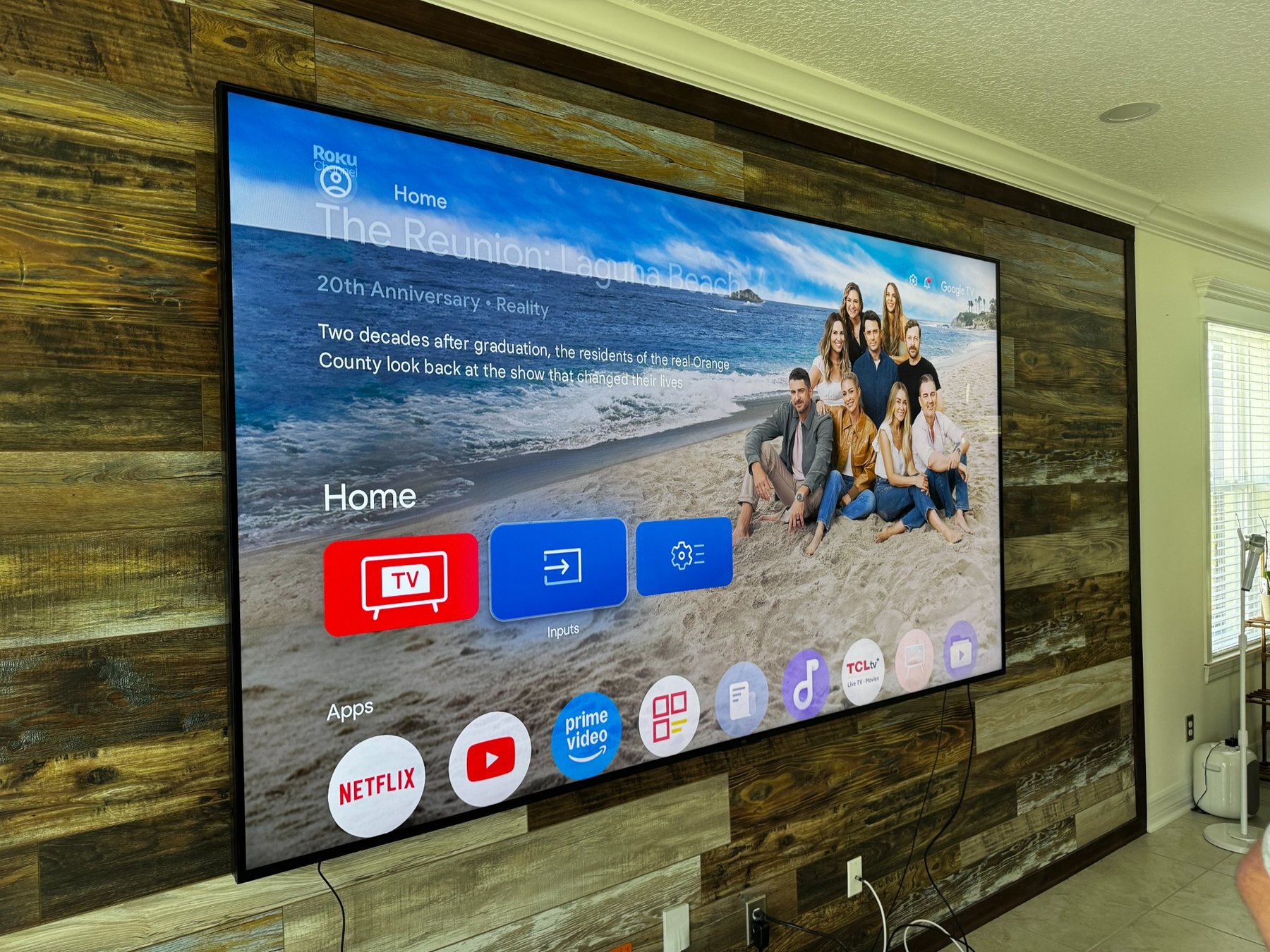 SkyVision large-format television mounted on a wood feature wall